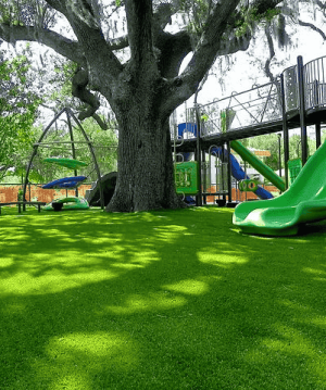 Safe, padded synthetic turf for a children's playground area to prevent injuries and mud.